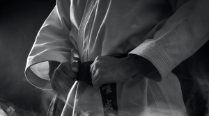 Shows a practitioner wearing a Taekwondo Black Belt which shows the level required for taekwondo to be effective at the highest levels.