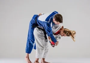 A picture of Judo for kids. This shows a strong Judo girl performing a Judo technique which shows off her strength. This conveys the benefits of Judo for Kids